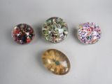 four different types of glass beads are sitting on a white surface
