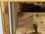 a gold clock that is sitting on a table