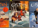 three books of western fiction are lined up on a table