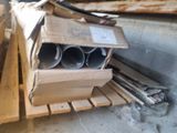 a pile of pipes and pipes on a pallet in a warehouse