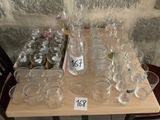 bottles and glasses on a table with price tags on them