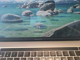 a laptop computer sitting on top of a desk next to a keyboard