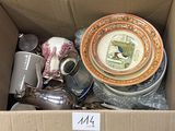 a cardboard box filled with assorted dishes and cups