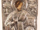 an antique silver plate with a picture of a man holding a book