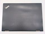 the back of a black laptop computer sitting on top of a white surface