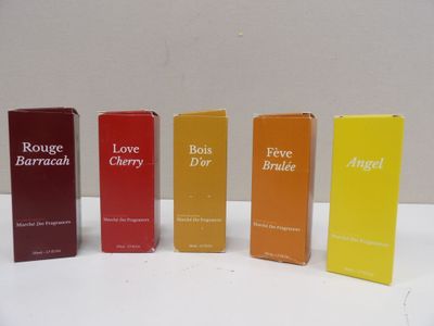 four different types of perfumes are lined up on a table