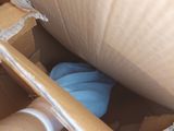 a cardboard box with a blue glove inside of it