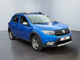 the blue dacia is parked in a room with a black floor