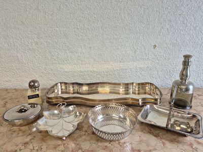 a table with a lot of silver items on it