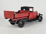 a red truck that is sitting on a white surface