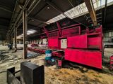 a large red machine that is sitting in a building