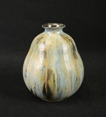 a small vase that is sitting on a black surface