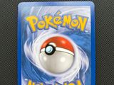 a close up of a pokemon card on a black surface
