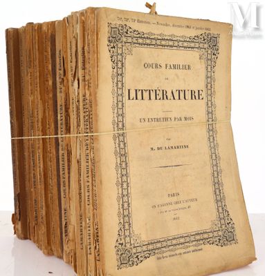 several old books stacked on top of each other on a table