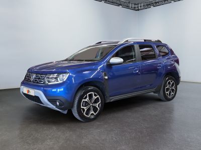 the blue car is parked in a large room with white walls
