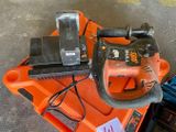 an orange and black chainsaw sitting on top of an orange box