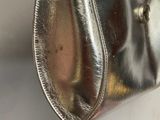 a silver purse hanging on a wall in a room
