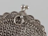 an image of a silver purse with a chain around it