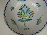 a white plate with blue and yellow designs on it