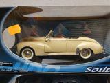 une petite voiture jaune dans une boîte posée sur une table