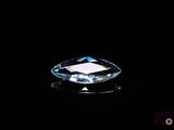 a close up of a faceted blue diamond on a black background