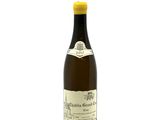 a bottle of wine that is sitting on a white surface