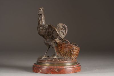 bronze statue of a bird with a basket on a marble base