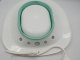 a white plate with a green bowl and a white mouse on it