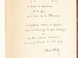 an open book with a handwritten poem on it sitting on a table