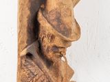 wooden sculpture of a man with a hat and a beard