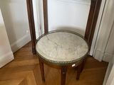 a small table with a vase on top of it