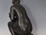statue of a woman sitting on a shell with a flower in her hair