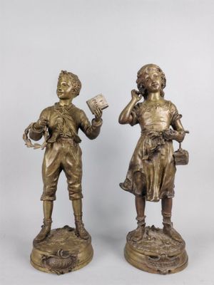 pair of antique bronze figurines of a boy and a girl