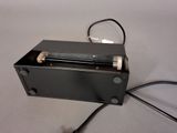 a black box with a metal handle on a table