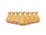 a row of wooden bowling pins lined up on a white surface