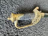 a close up of a sword on a carpeted surface