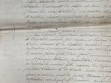 an old document with writing on it sitting on a table