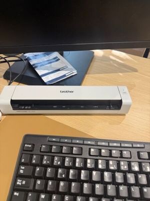 a stapler sitting on top of a desk next to a keyboard