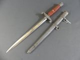 pair of old swords with wooden handle on grey surface