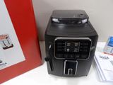 a coffee machine sitting next to a box on a table