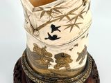 a vase that is sitting on top of a wooden stand