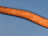 a close up of a wooden spoon on a blue surface
