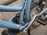 a blue bicycle that is parked in a garage