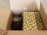 someone is opening a box with a beverage in it on the floor