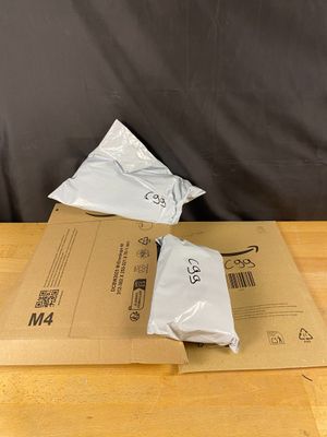 two bags of food sitting on top of a wooden table