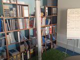 a room with bookshelves and a whiteboard in it