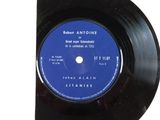 a black vinyl record with a blue label on it