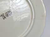 a white plate with a design on it on a table