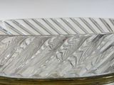 a glass bowl on a stand on a white surface