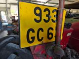 a yellow and black sign on a pole in a garage